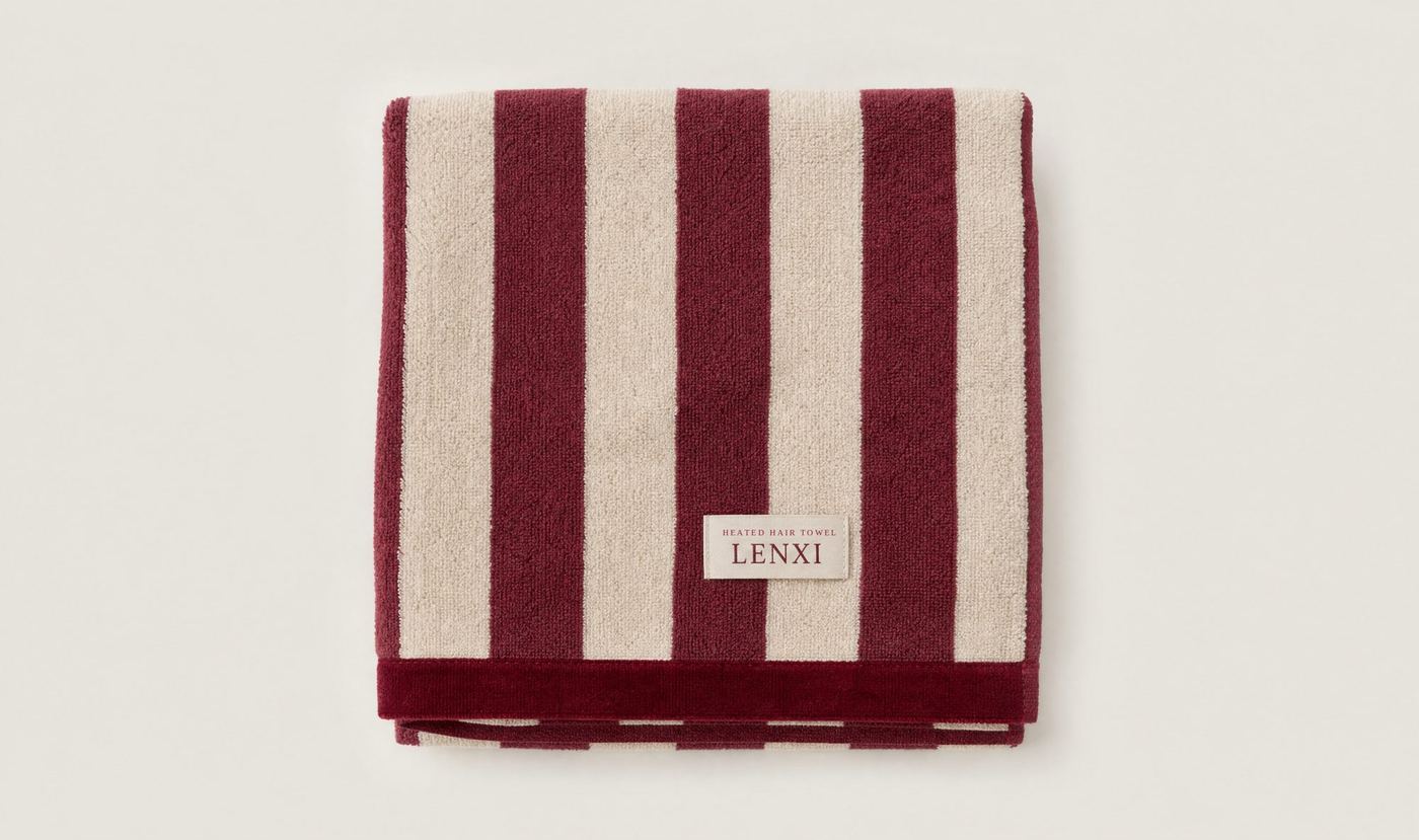 A folded LENXI towel in burgundy and cream stripes with a cotton velvet border